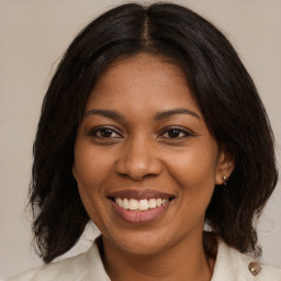 Joyful black young-adult female with medium  brown hair and brown eyes