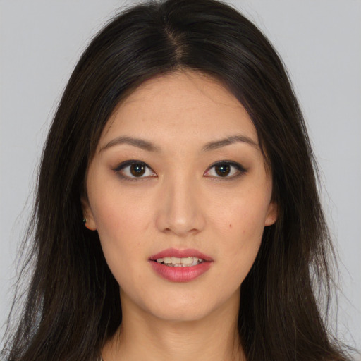 Joyful white young-adult female with long  brown hair and brown eyes