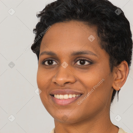 Joyful black young-adult female with short  brown hair and brown eyes