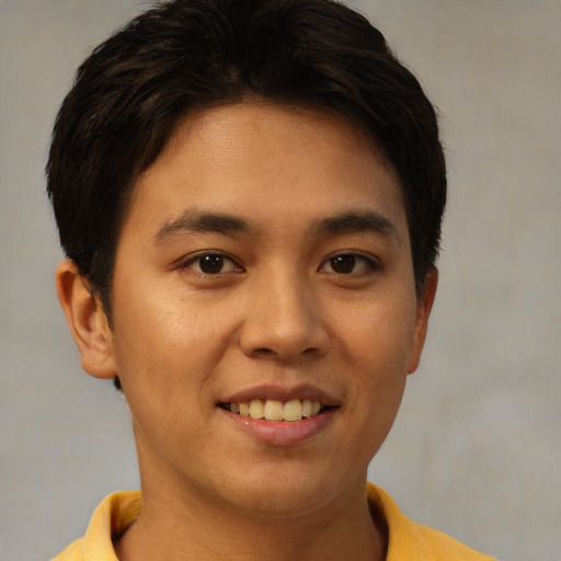 Joyful asian young-adult male with short  brown hair and brown eyes
