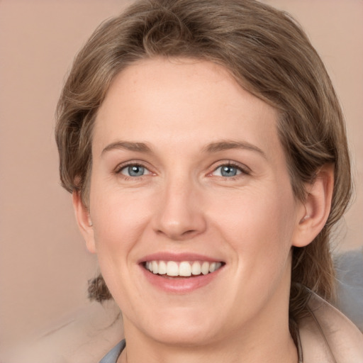 Joyful white young-adult female with medium  brown hair and grey eyes