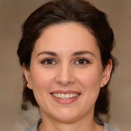 Joyful white young-adult female with medium  brown hair and brown eyes