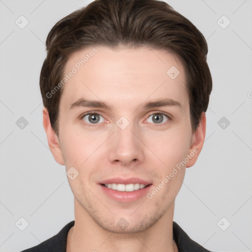 Joyful white young-adult male with short  brown hair and grey eyes