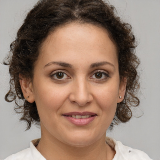 Joyful white adult female with medium  brown hair and brown eyes