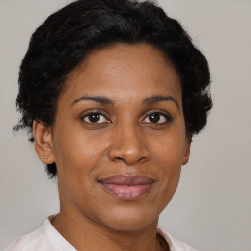 Joyful latino adult female with short  brown hair and brown eyes