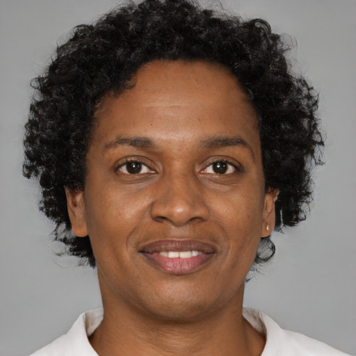 Joyful black young-adult female with short  brown hair and brown eyes