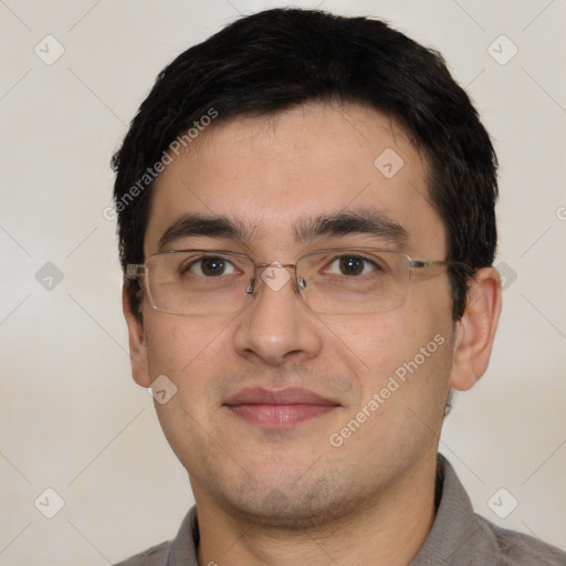 Joyful white young-adult male with short  black hair and brown eyes