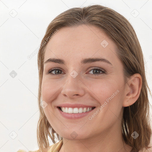 Joyful white young-adult female with long  brown hair and grey eyes