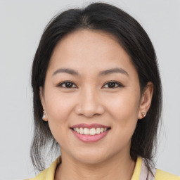 Joyful latino young-adult female with medium  brown hair and brown eyes