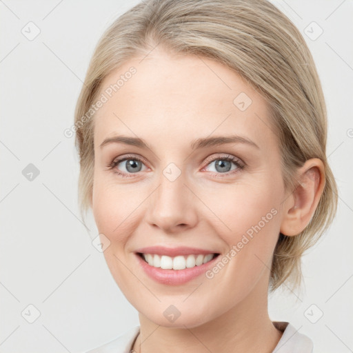 Joyful white young-adult female with medium  brown hair and blue eyes