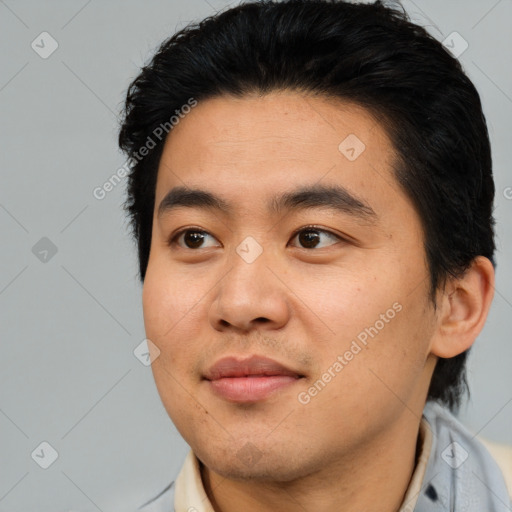 Joyful asian young-adult male with short  black hair and brown eyes