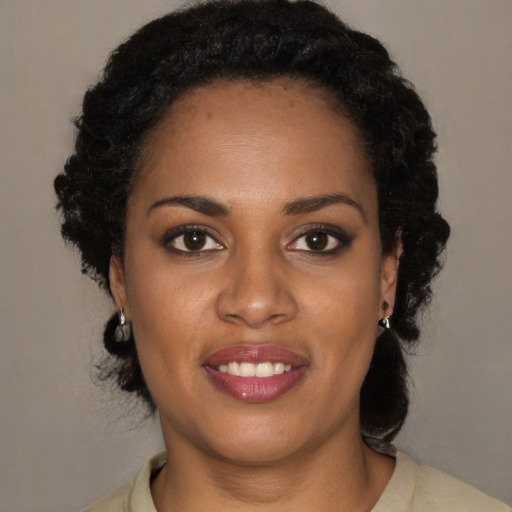 Joyful black young-adult female with medium  brown hair and brown eyes