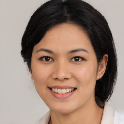 Joyful asian young-adult female with medium  brown hair and brown eyes