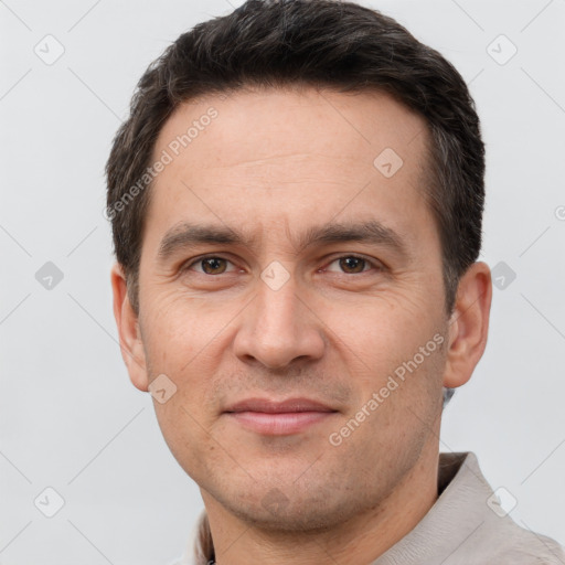 Joyful white adult male with short  brown hair and brown eyes