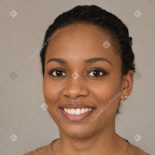 Joyful black young-adult female with short  black hair and brown eyes