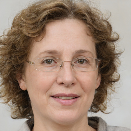 Joyful white adult female with medium  brown hair and blue eyes