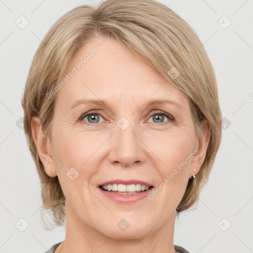 Joyful white adult female with medium  brown hair and grey eyes