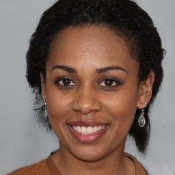 Joyful black young-adult female with medium  brown hair and brown eyes