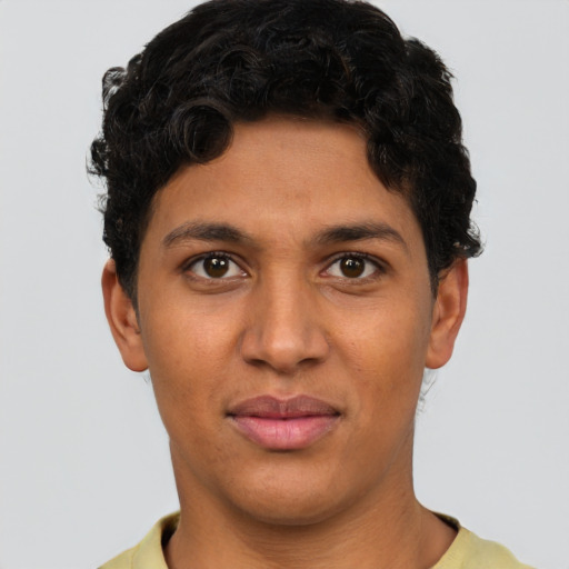 Joyful latino young-adult male with short  brown hair and brown eyes