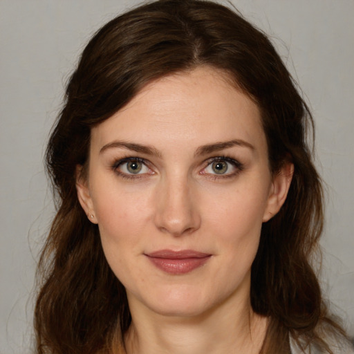 Joyful white young-adult female with medium  brown hair and green eyes