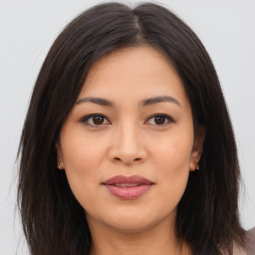Joyful asian young-adult female with long  brown hair and brown eyes