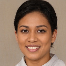 Joyful latino young-adult female with short  brown hair and brown eyes