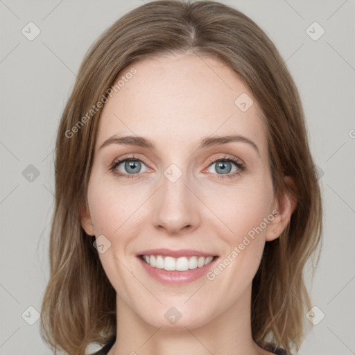 Joyful white young-adult female with medium  brown hair and blue eyes