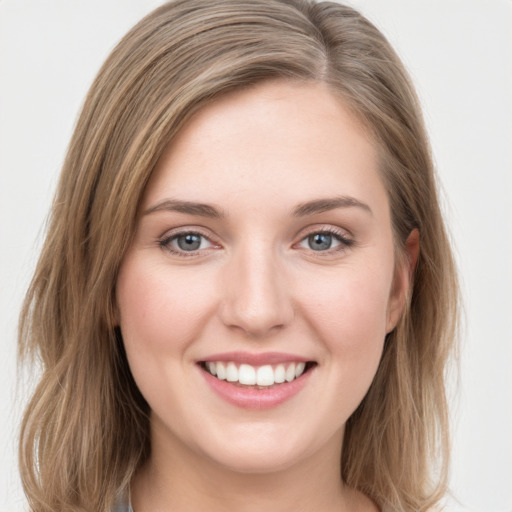 Joyful white young-adult female with long  brown hair and grey eyes