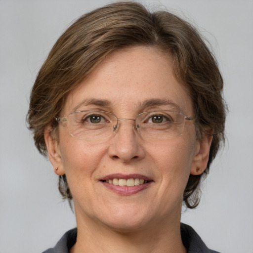 Joyful white adult female with medium  brown hair and grey eyes