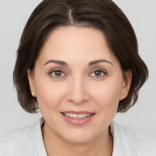 Joyful white young-adult female with medium  brown hair and brown eyes