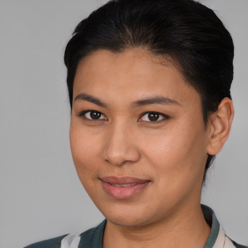 Joyful latino young-adult female with short  brown hair and brown eyes