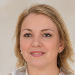 Joyful white young-adult female with medium  brown hair and blue eyes