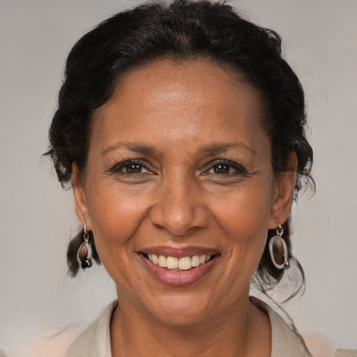 Joyful black adult female with medium  brown hair and brown eyes