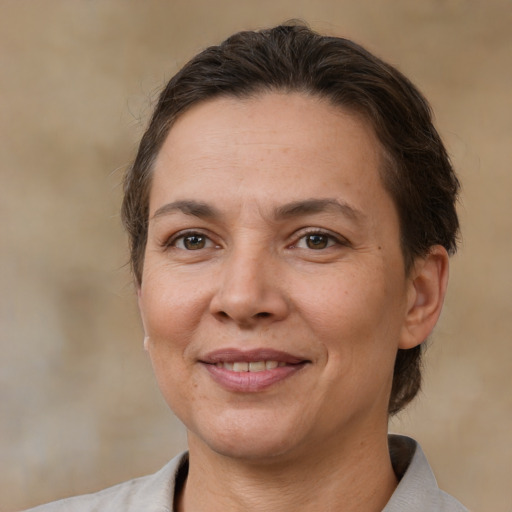 Joyful white adult female with medium  brown hair and brown eyes