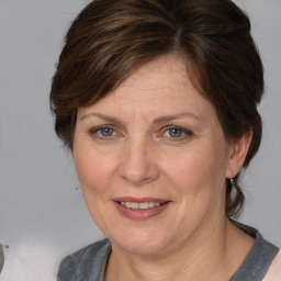 Joyful white adult female with medium  brown hair and grey eyes