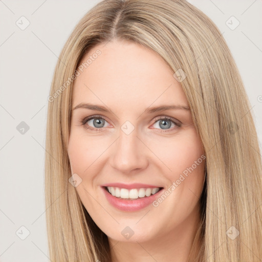 Joyful white young-adult female with long  brown hair and green eyes