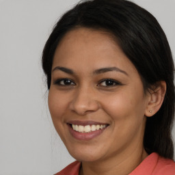 Joyful latino young-adult female with long  brown hair and brown eyes