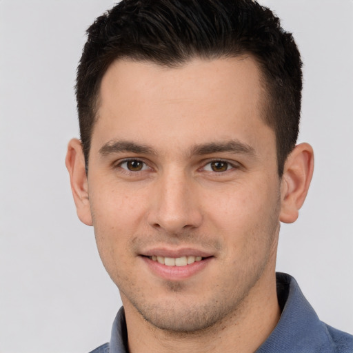 Joyful white young-adult male with short  brown hair and brown eyes