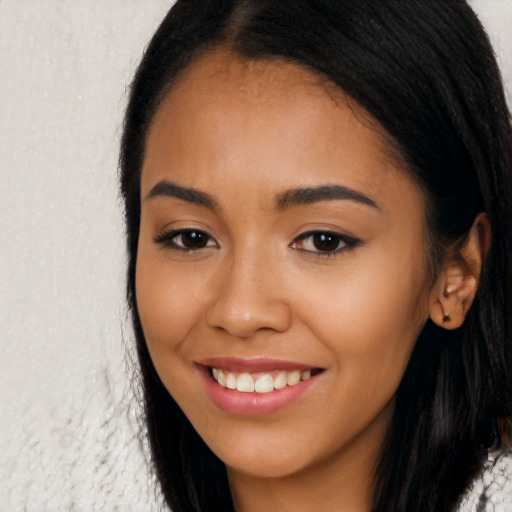 Joyful latino young-adult female with long  brown hair and brown eyes