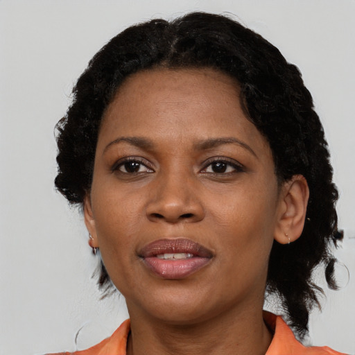 Joyful black adult female with short  black hair and brown eyes