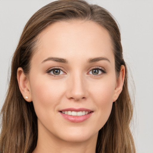 Joyful white young-adult female with long  brown hair and grey eyes