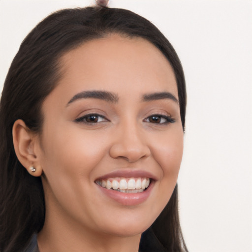 Joyful latino young-adult female with long  brown hair and brown eyes