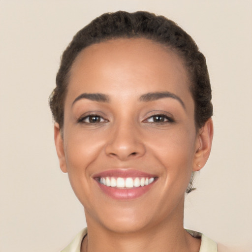 Joyful latino young-adult female with short  brown hair and brown eyes