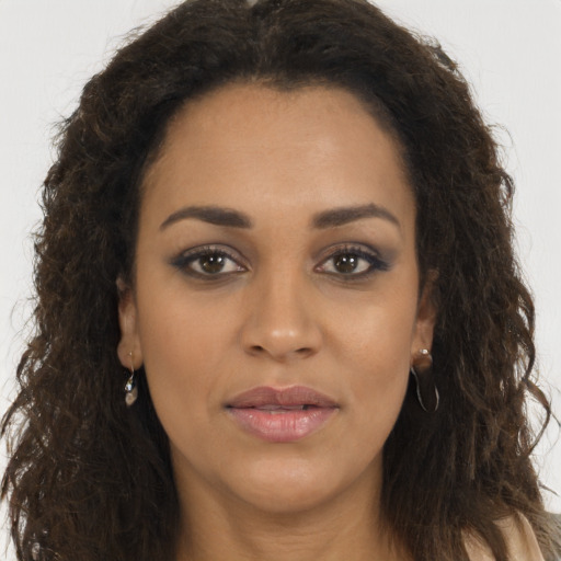 Joyful latino young-adult female with long  brown hair and brown eyes