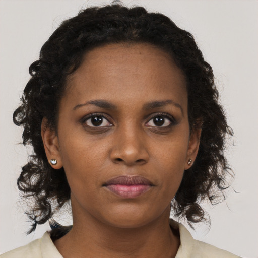 Neutral black young-adult female with medium  brown hair and brown eyes