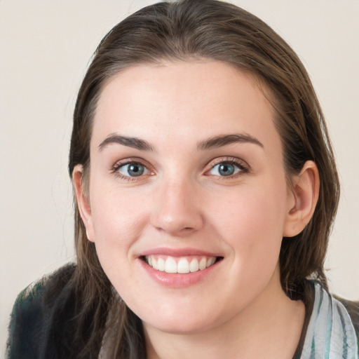 Joyful white young-adult female with long  brown hair and grey eyes