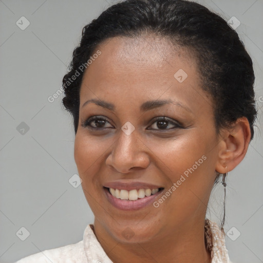 Joyful black young-adult female with medium  brown hair and brown eyes