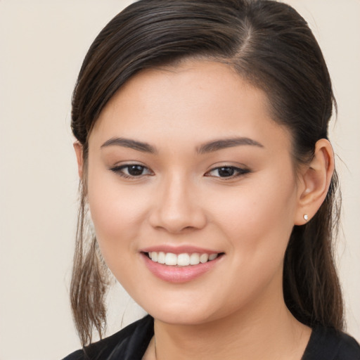 Joyful white young-adult female with long  brown hair and brown eyes