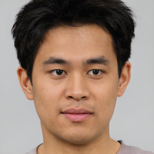 Joyful asian young-adult male with short  brown hair and brown eyes