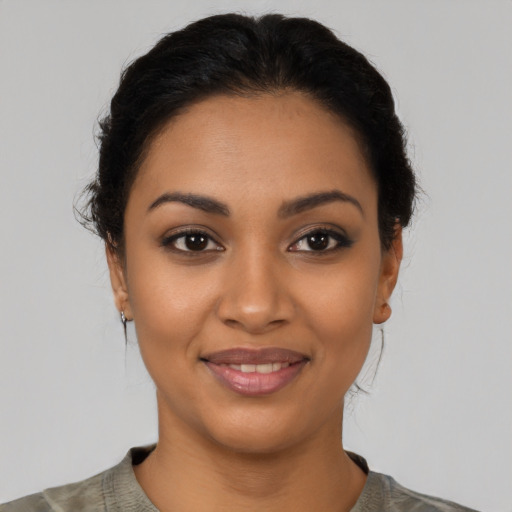 Joyful latino young-adult female with short  brown hair and brown eyes